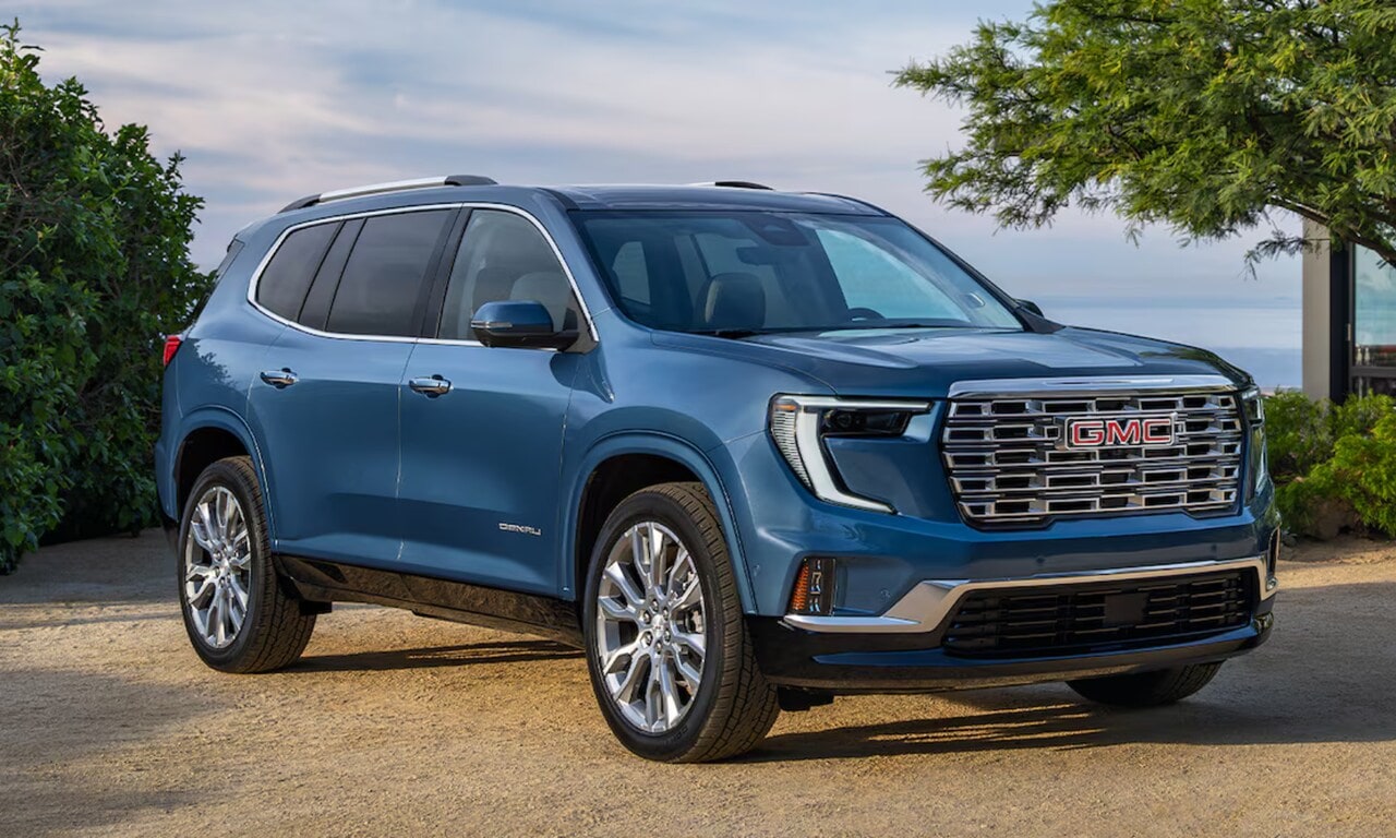 Exterior image of the 2026 GMC Acadia Denali parked in a coastal home