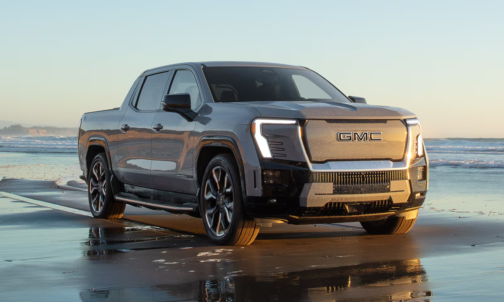 Exterior side image of a 2025 GMC Sierra EV Denali parked on a beach