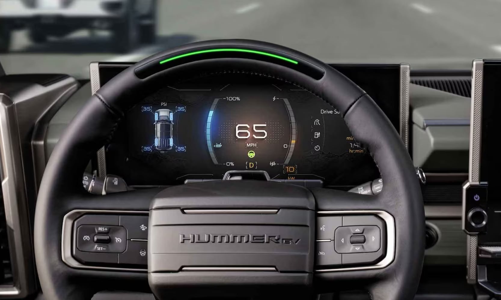 Closeup image of the 2026 GMC Hummer EV SUV SuperCruise hands-free driving system behind the steering wheel