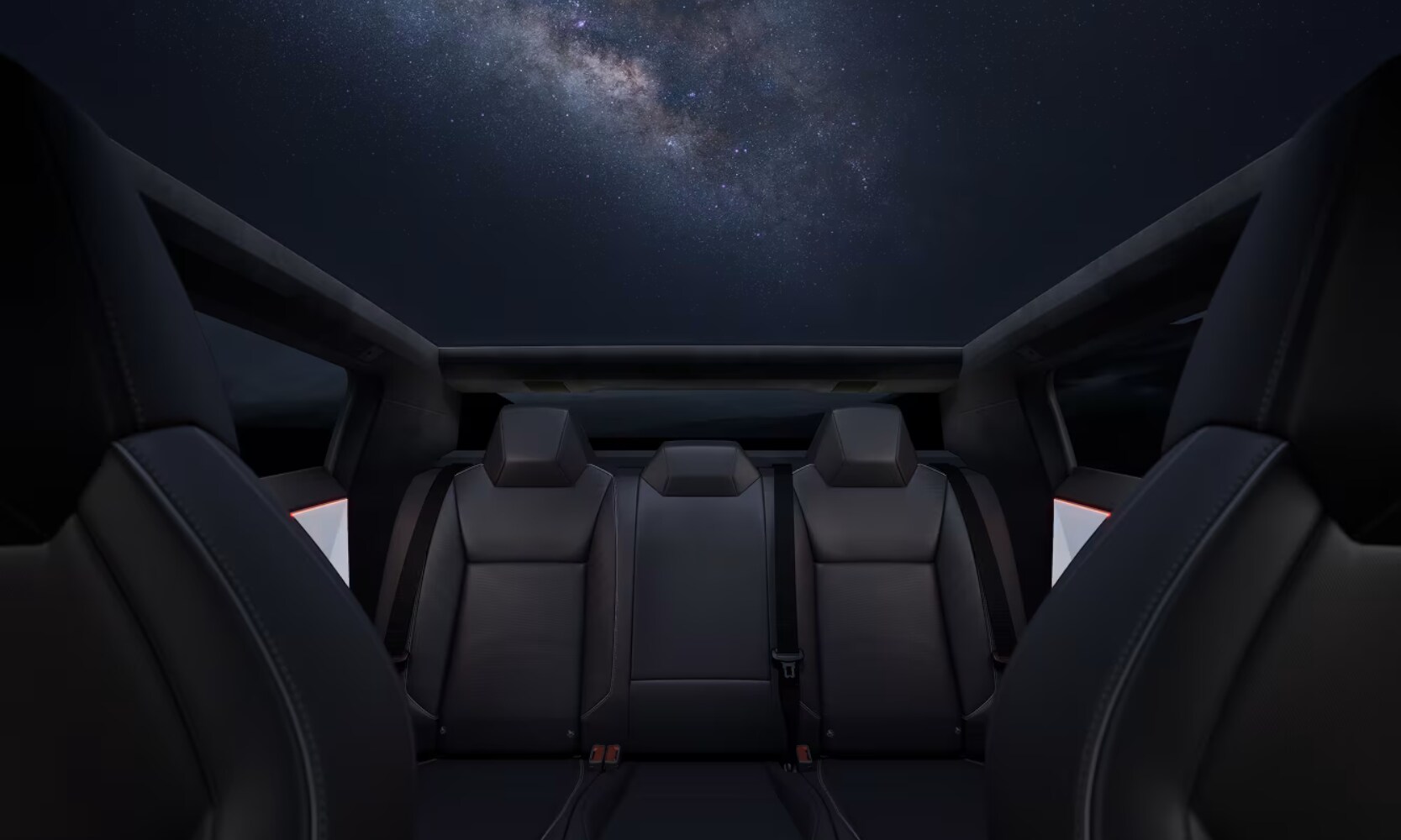 Closeup interior image of the 2025 Tesla Cybertruck cabin with black leatherette seats and a space-patterned roof