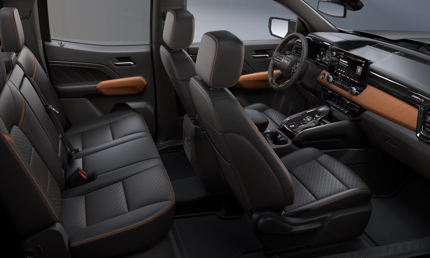 Interior top-view image of a 2026 GMC Canyon charcoal black and tan two-row seating cabin