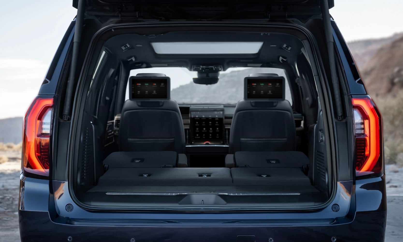rear interior cargo area inside the 2025 GMC Yukon with the rear seats folded down