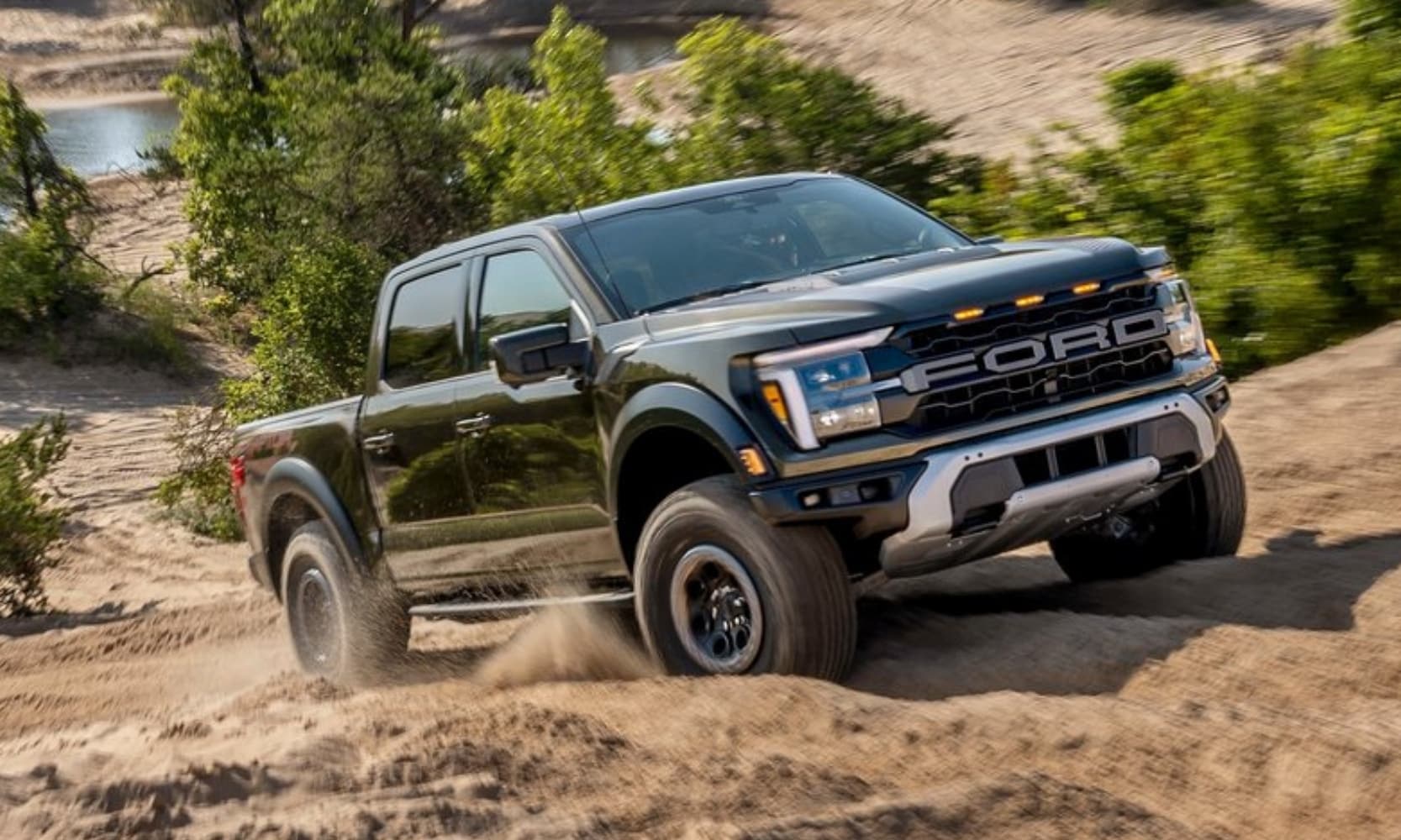 Image of a green 2025 Ford F-150 Raptor off-roading in the desert