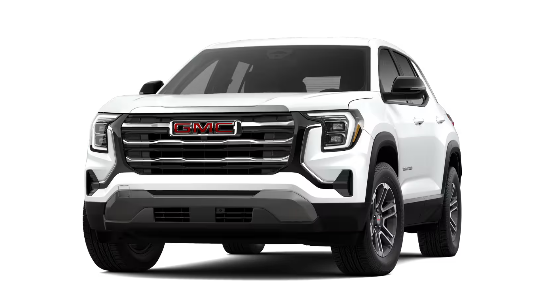 Exterior front hero image of a white 2026 GMC Terrain AT4 on a dirt road in the woods