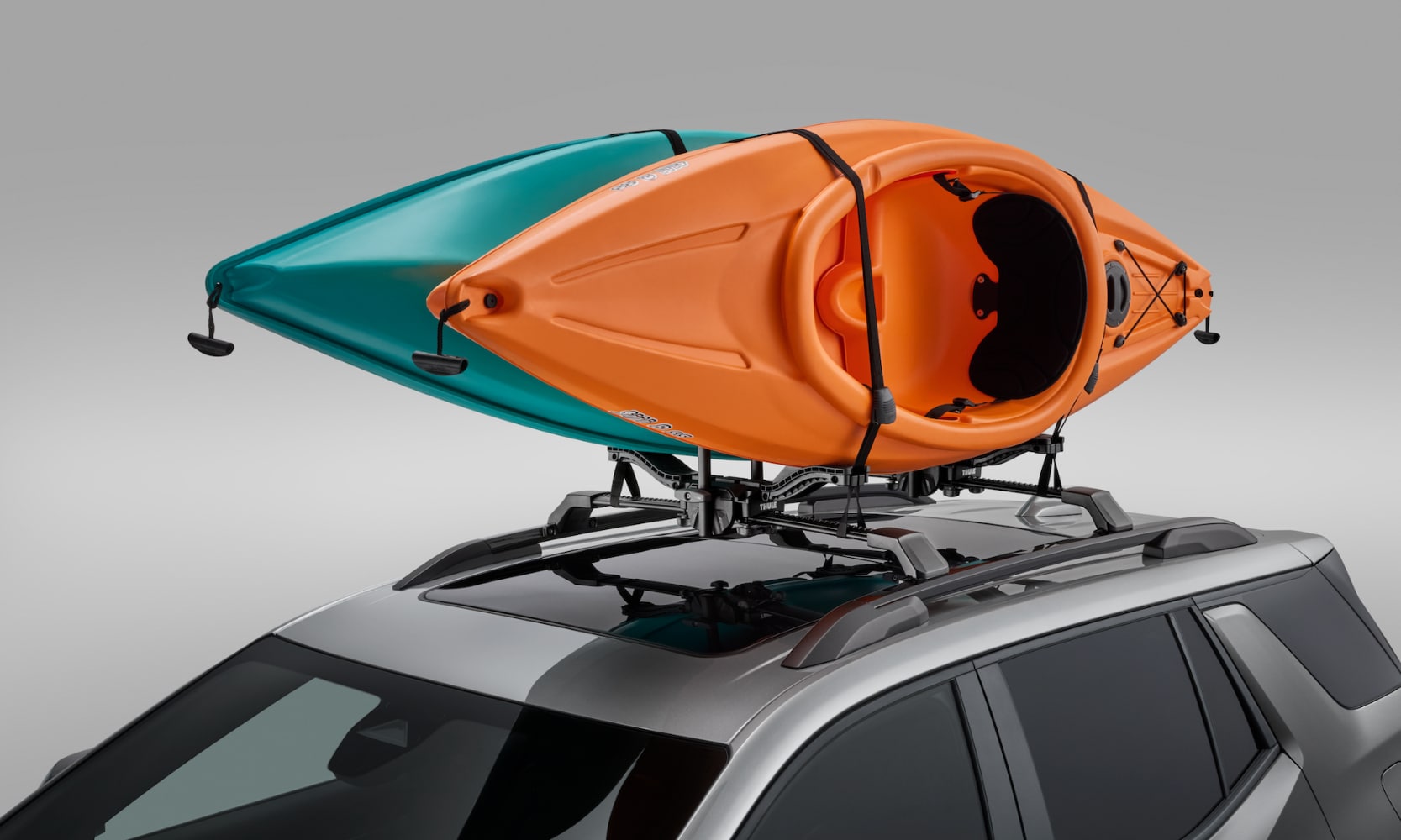 Exterior image of a green and orange kayak mounted on a 2025 GMC Terrain roof