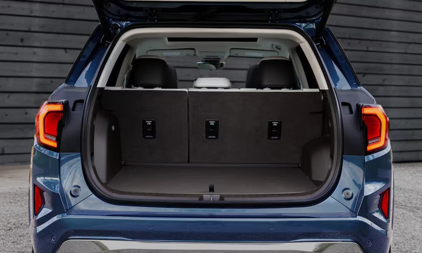 Exterior rear-view image of a blue 2026 GMC Terrain opened trunk