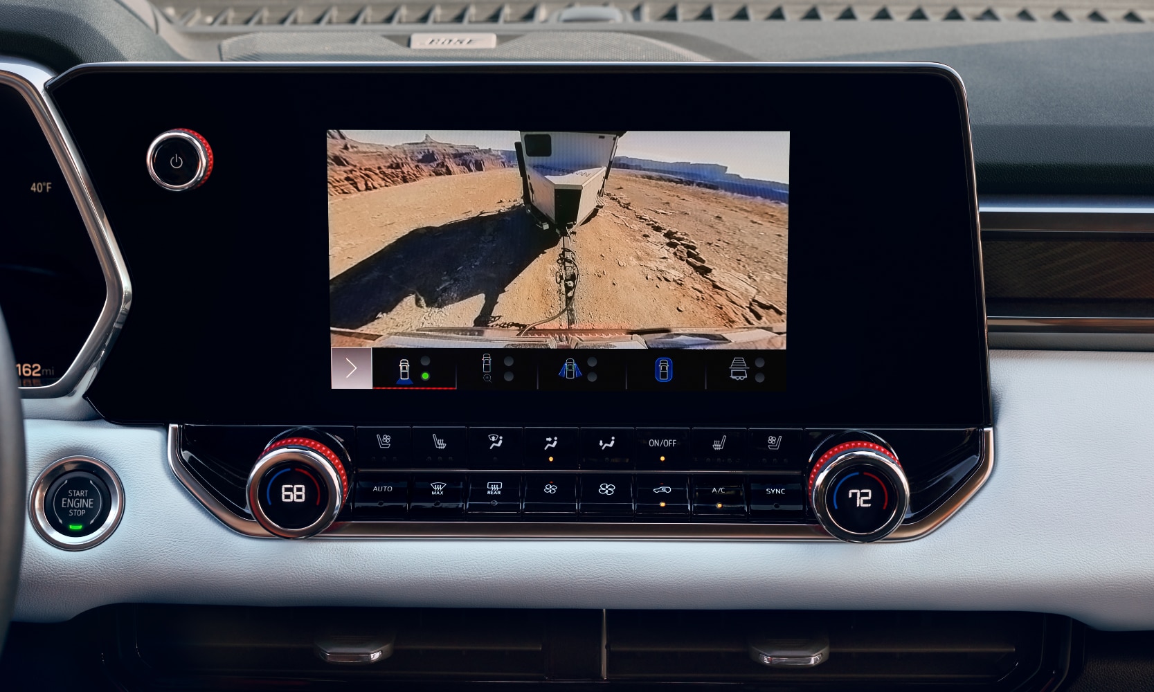 Closeup interior image of a 2026 GMC Canyon AT4X's camera displaying views of the trailer it's towing