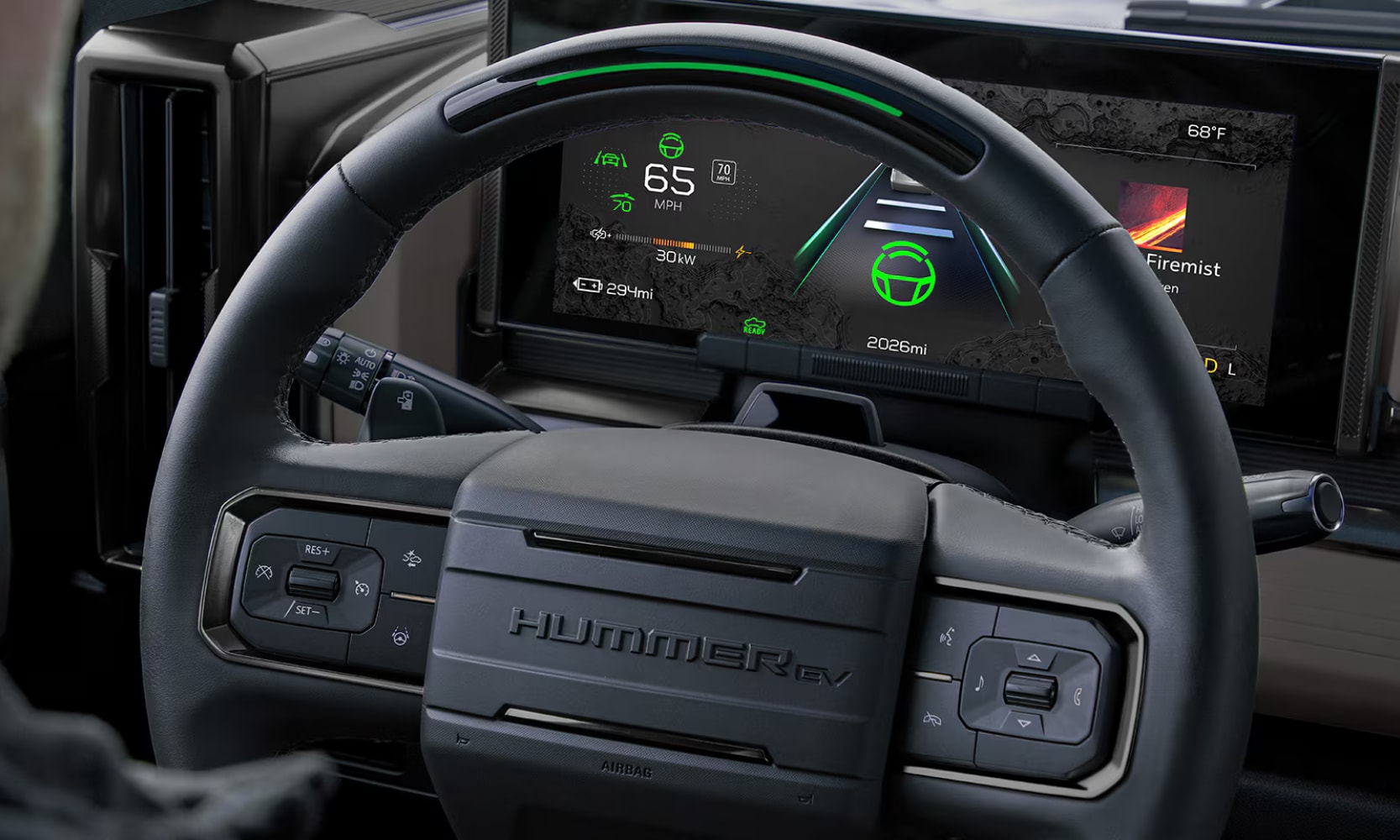 Closeup image of the 2026 GMC Hummer EV Pickup Super Cruise technology with a display behind the steering wheel