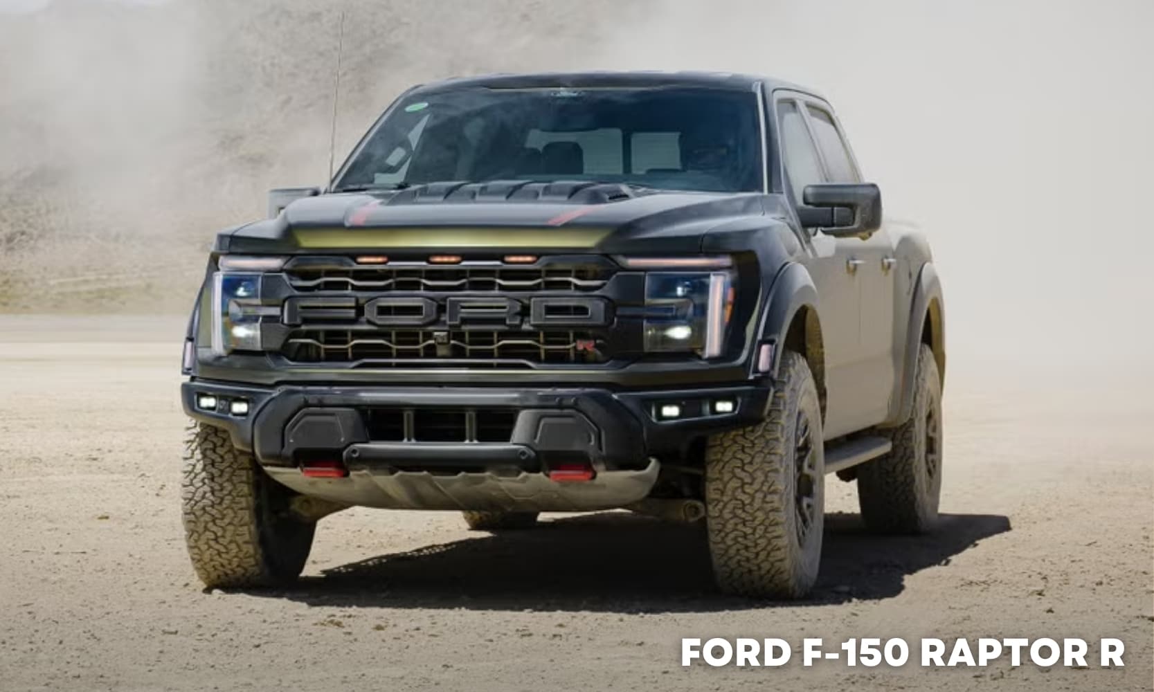 Image of a green 2025 Ford F-150 Raptor R driving in a sandy mountain landscape