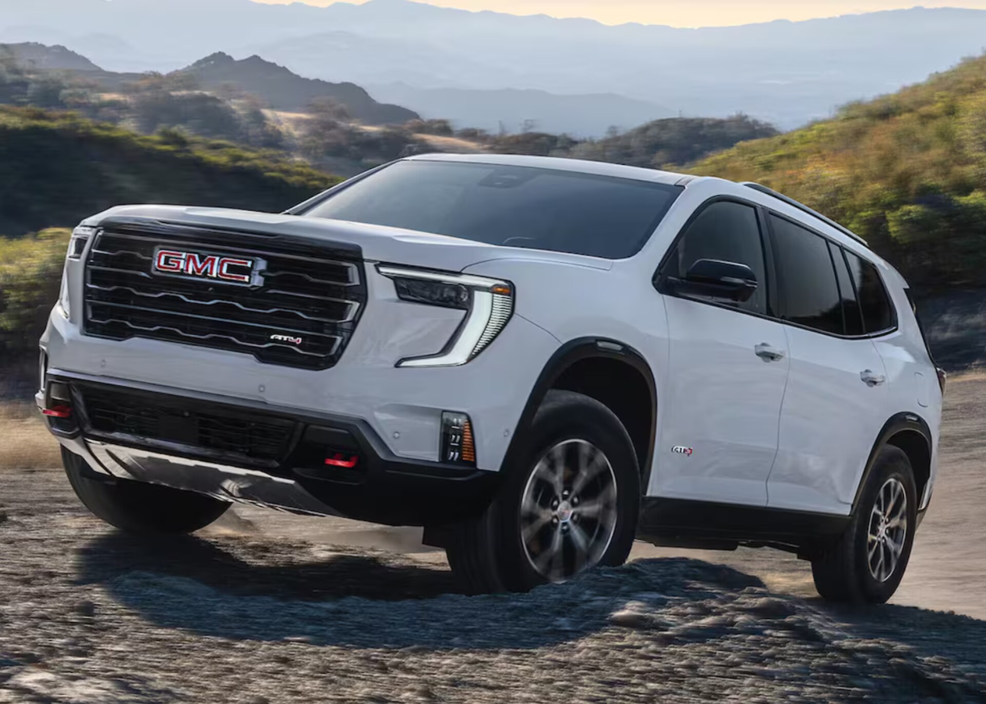 2026 GMC Acadia driving off-road in mountainous terrain