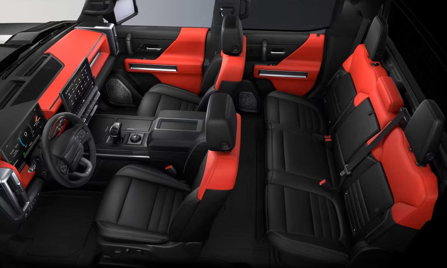 Top-view interior image of a 2026 GMC Hummer EV Truck red-orange and black leather seats and cabin