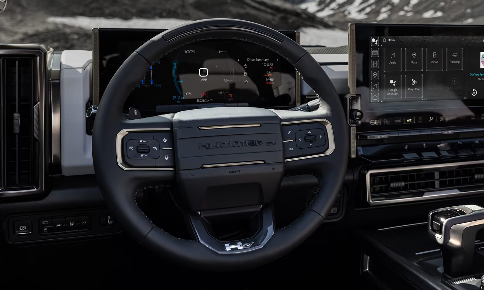 Closeup image of the 2025 GMC Hummer EV Truck's driving features displayed behind the steering wheel