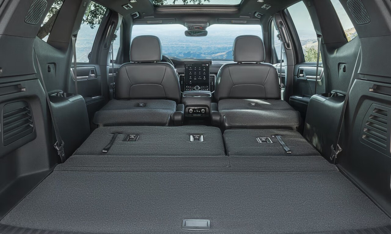 Interior image of the 2026 GMC Acadia cargo space with the rear two rows folded flat
