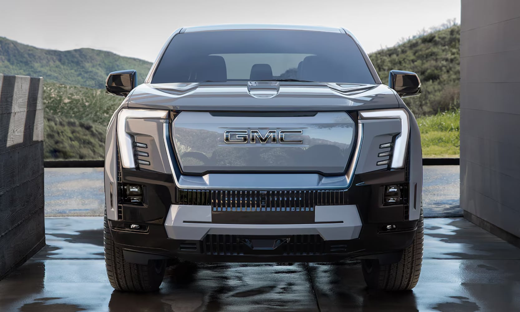 Exterior front-view image of a 2025 GMC Sierra EV Denali parked in home garage