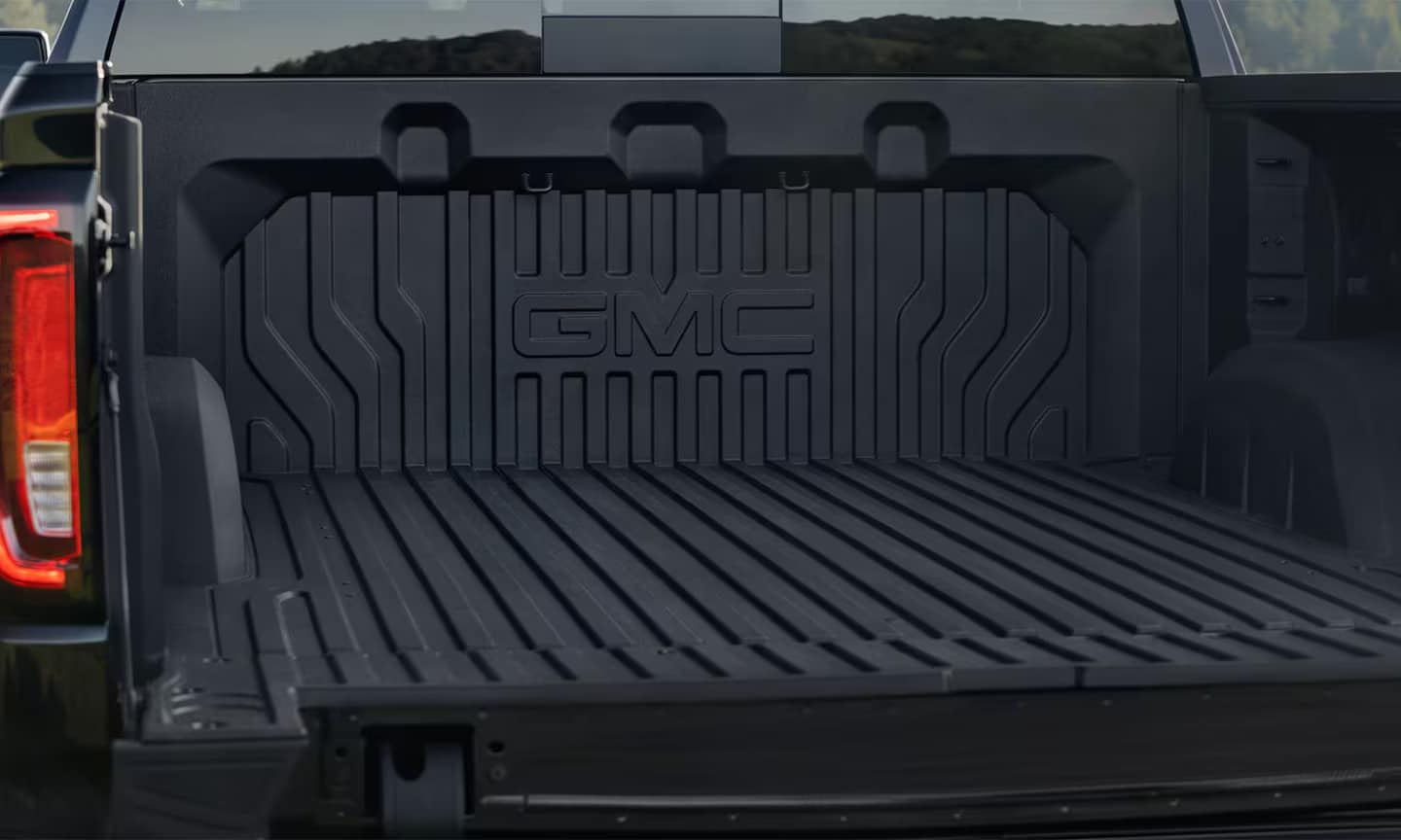 Closeup exterior image of the 2026 GMC Sierra 1500 open cargo bed