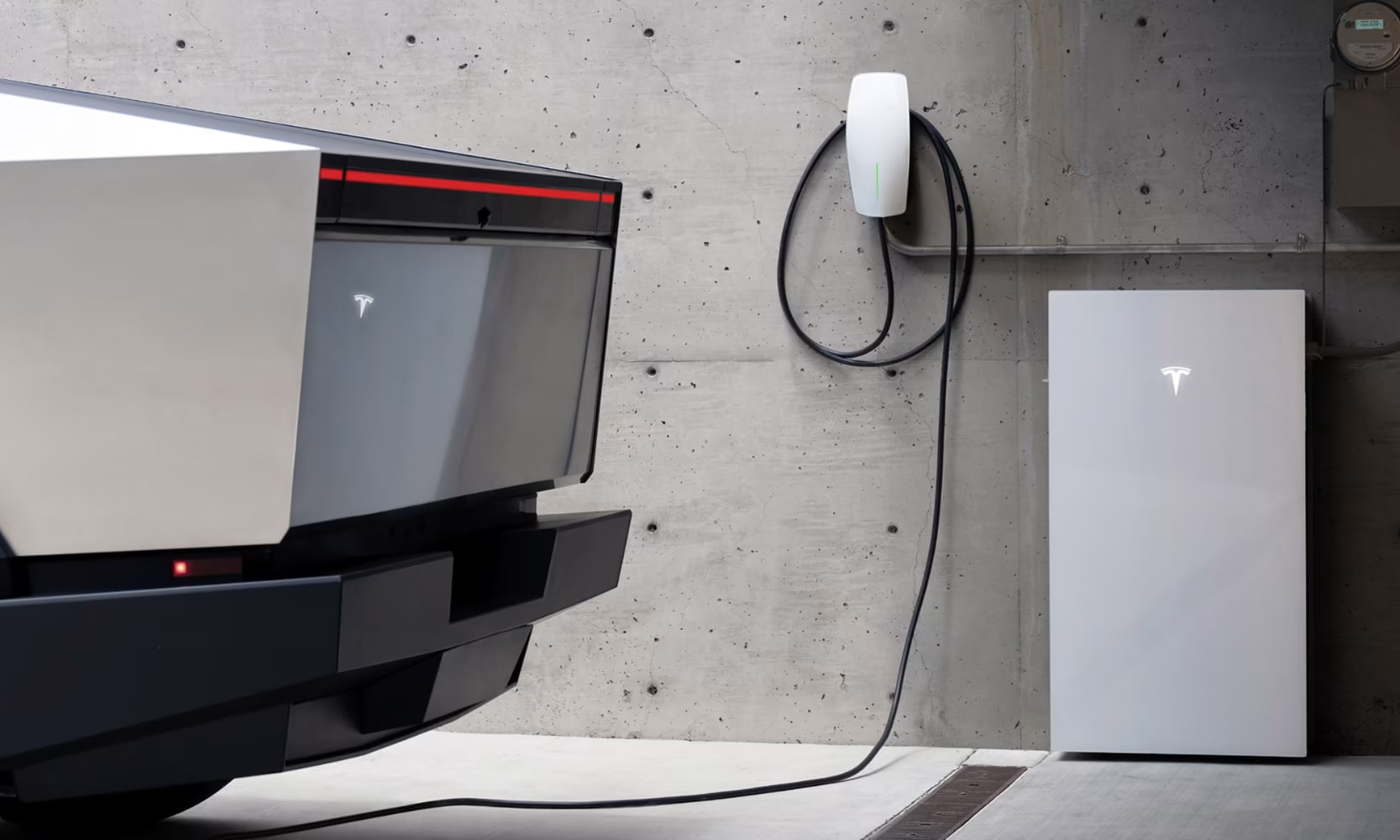 Closeup side image of a silver 2025 Tesla Cybertruck charging in a garage