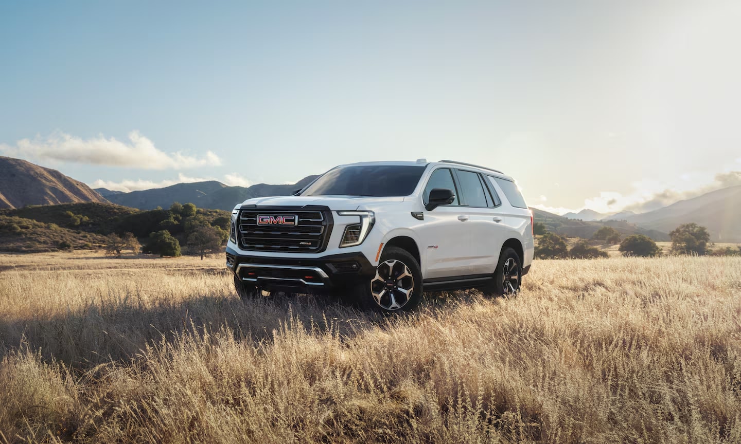 Exterior image of a 2026 GMC Yukon AT4 parked in open mountain field