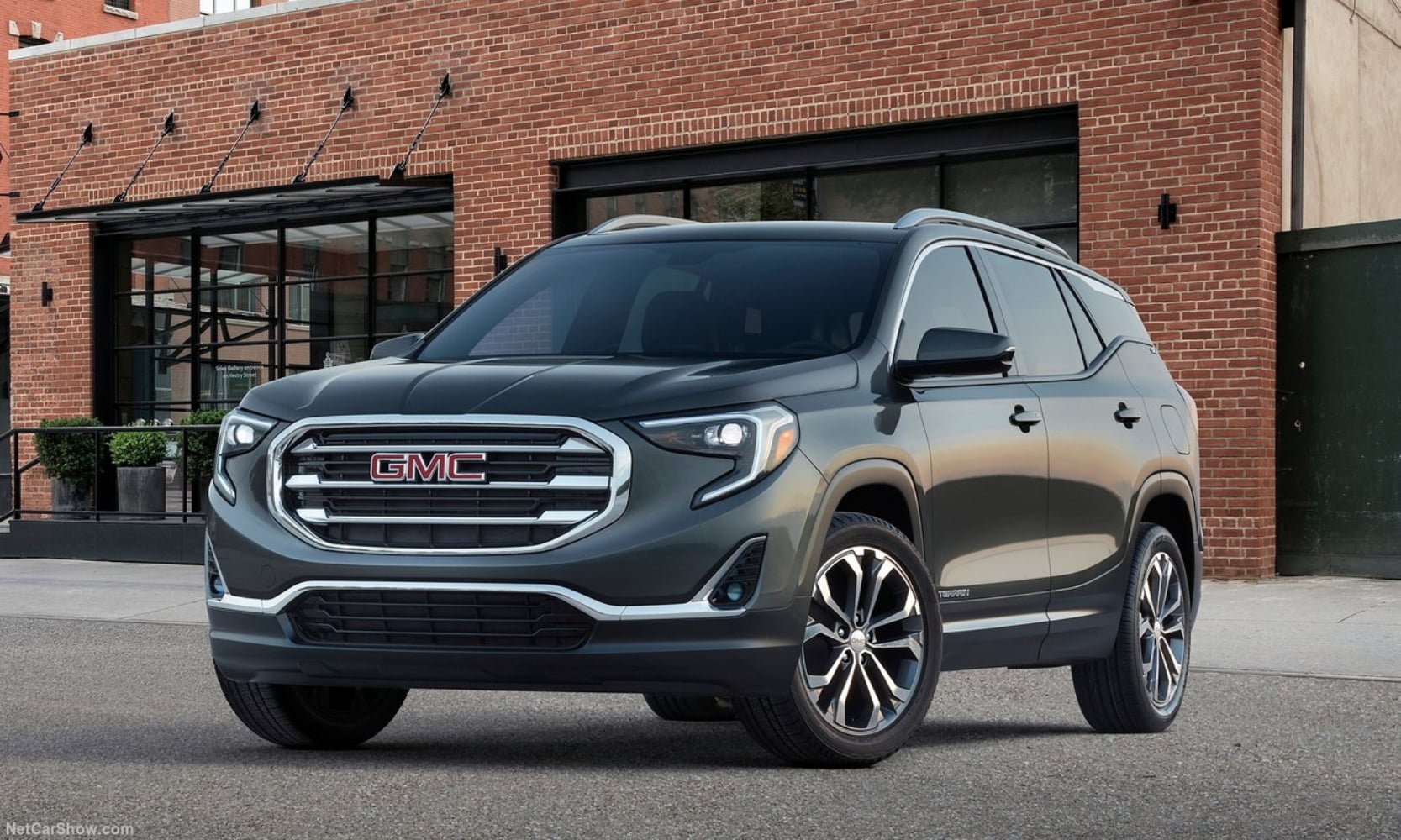 Exterior front image of a matte black 2018 GMC Terrain parked in front of city buildings