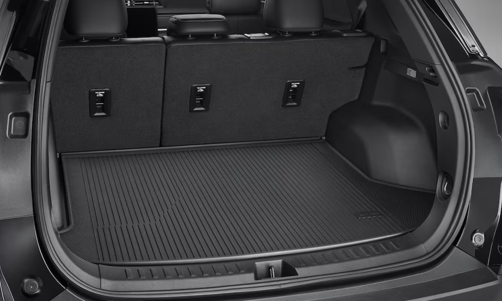 Exterior image of the 2025 GMC Terrain Elevation trunk cargo space with dark gray colors and the door opened