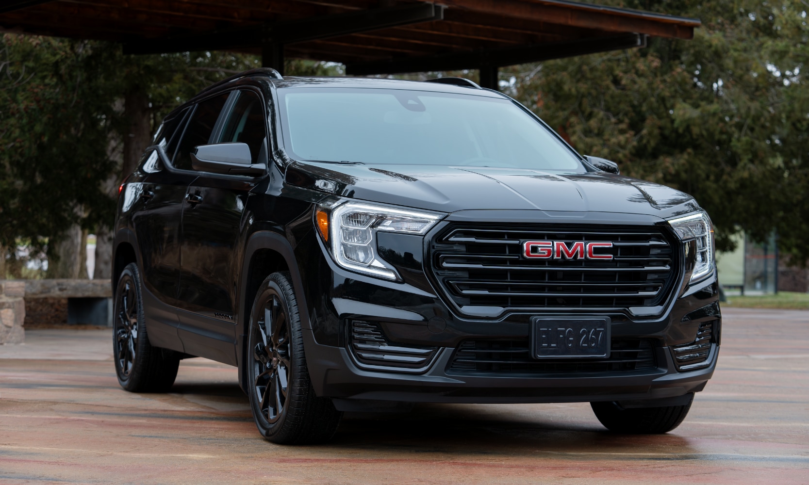 Exterior front image of a black 2024 GMC Terrain Elevation parked in a park setting
