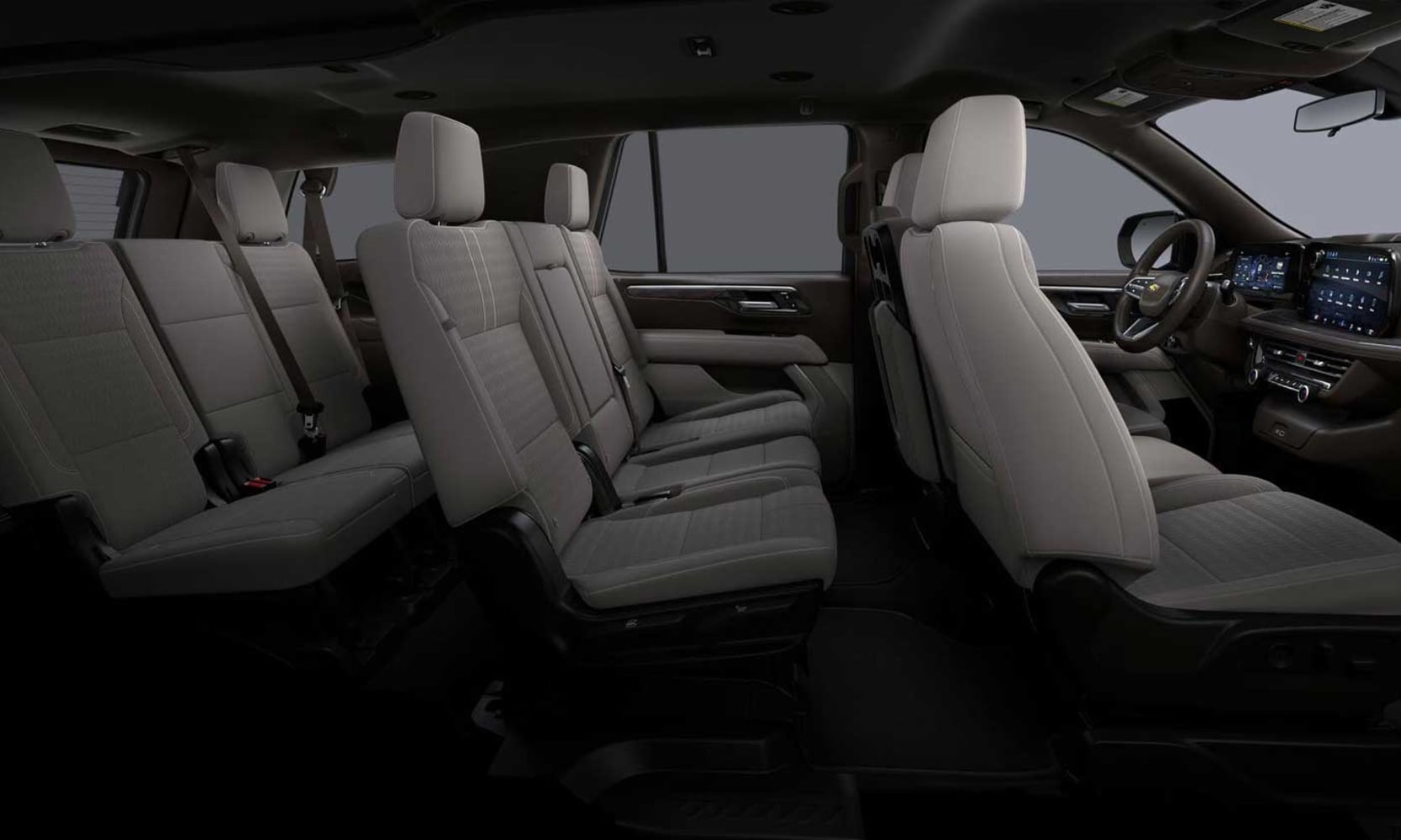 Interior side image of the 2026 Chevy Tahoe light gray three-row seating
