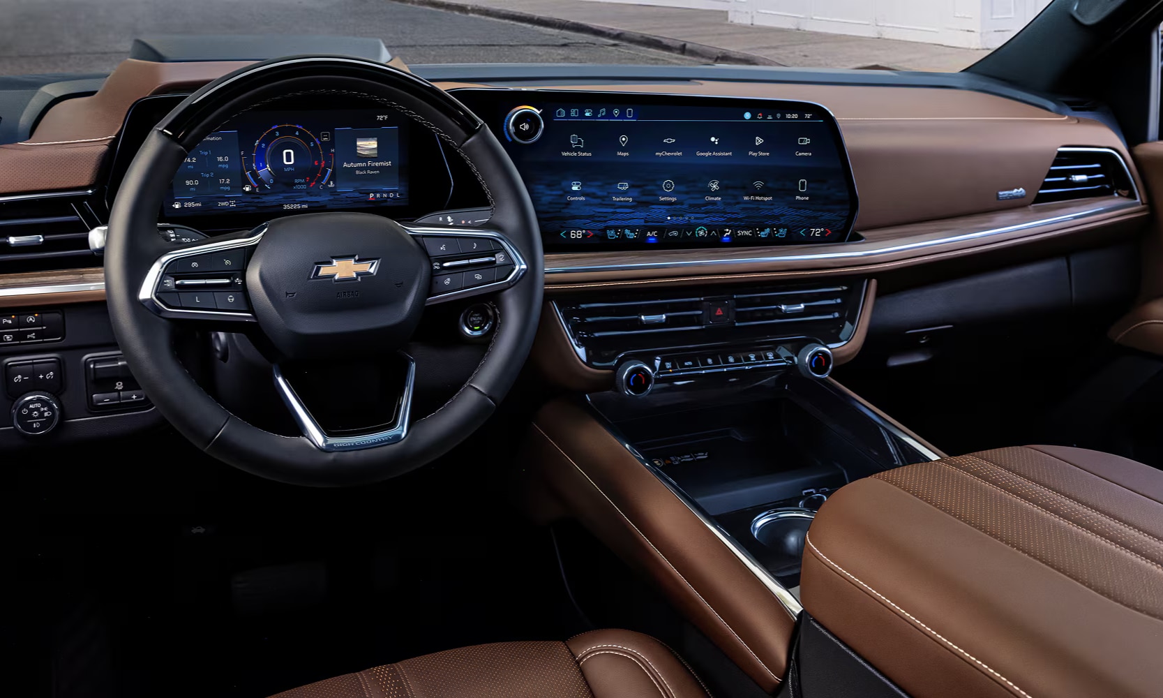 Interior image of the 2026 Chevy Tahoe tan leather seats and infotainment system in the first row