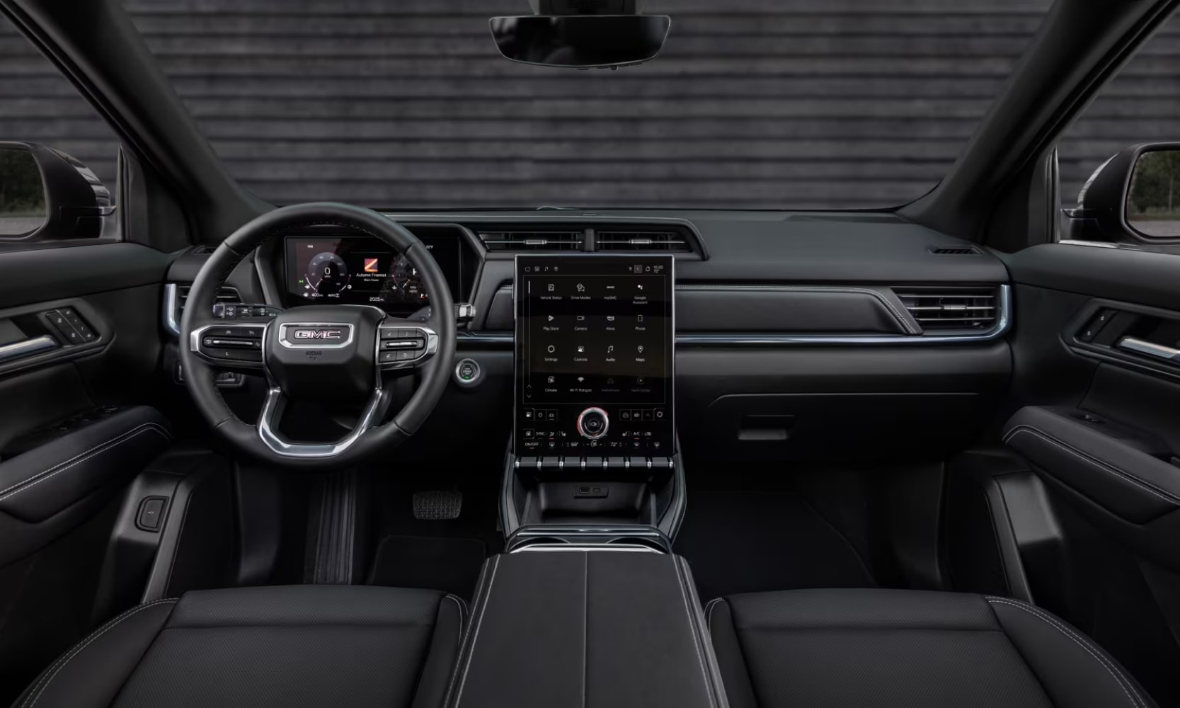 Interior image of the 2025 GMC Terrain AT4 dashboard, front seats, and infotainment system