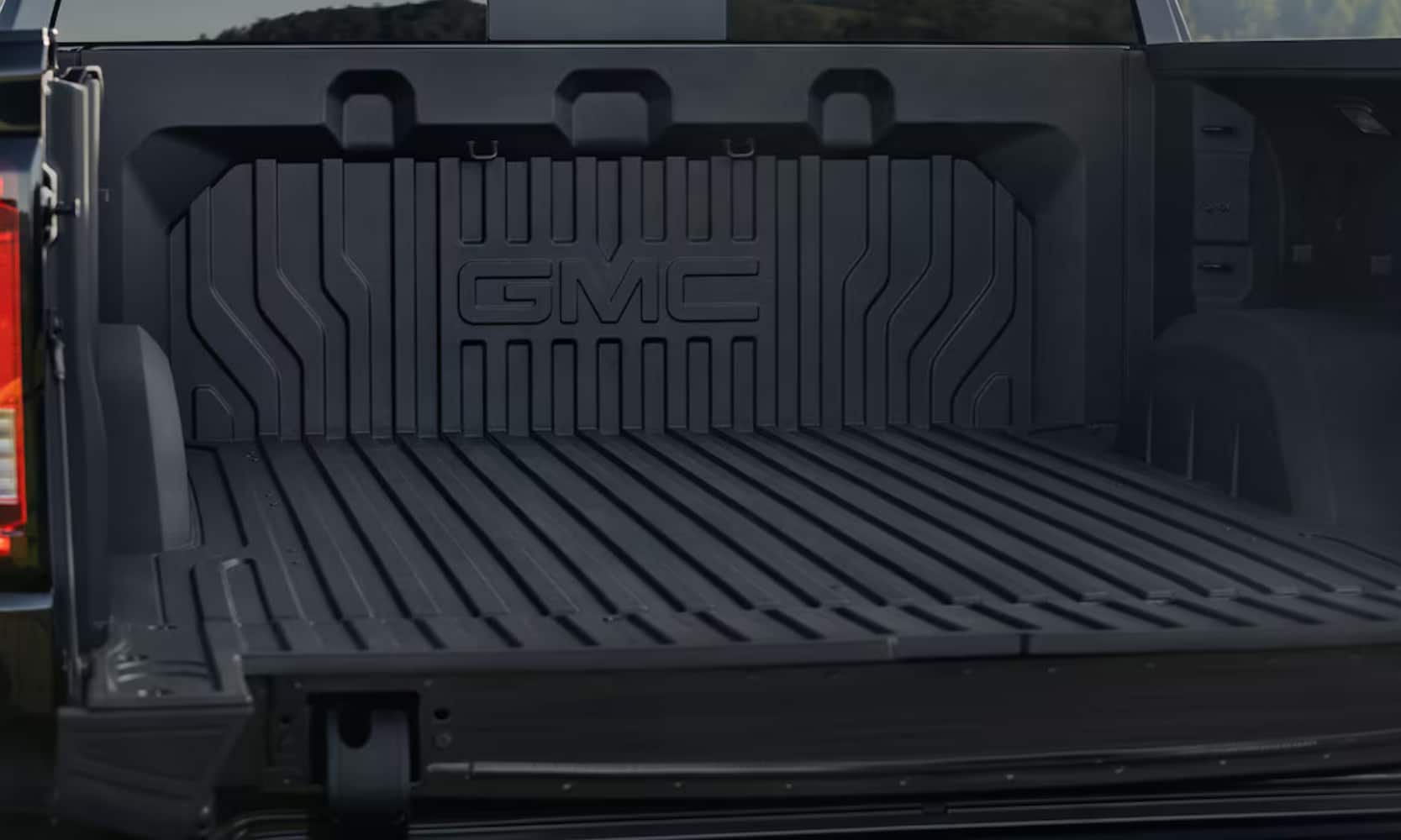 Close-up exterior image of the 2025 GMC Sierra 1500 opened cargo bed