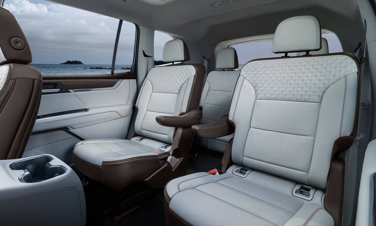 Interior image of the 2026 GMC Acadia white seats in the second and third row with beach views