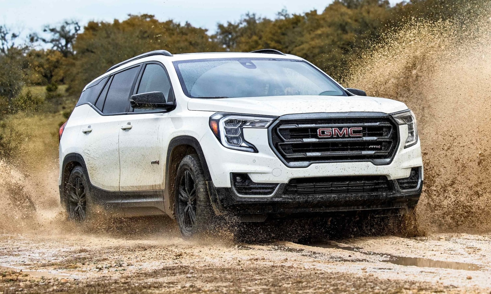 2023 GMC Terrain AT4 going off-road powering through thick mud puddles