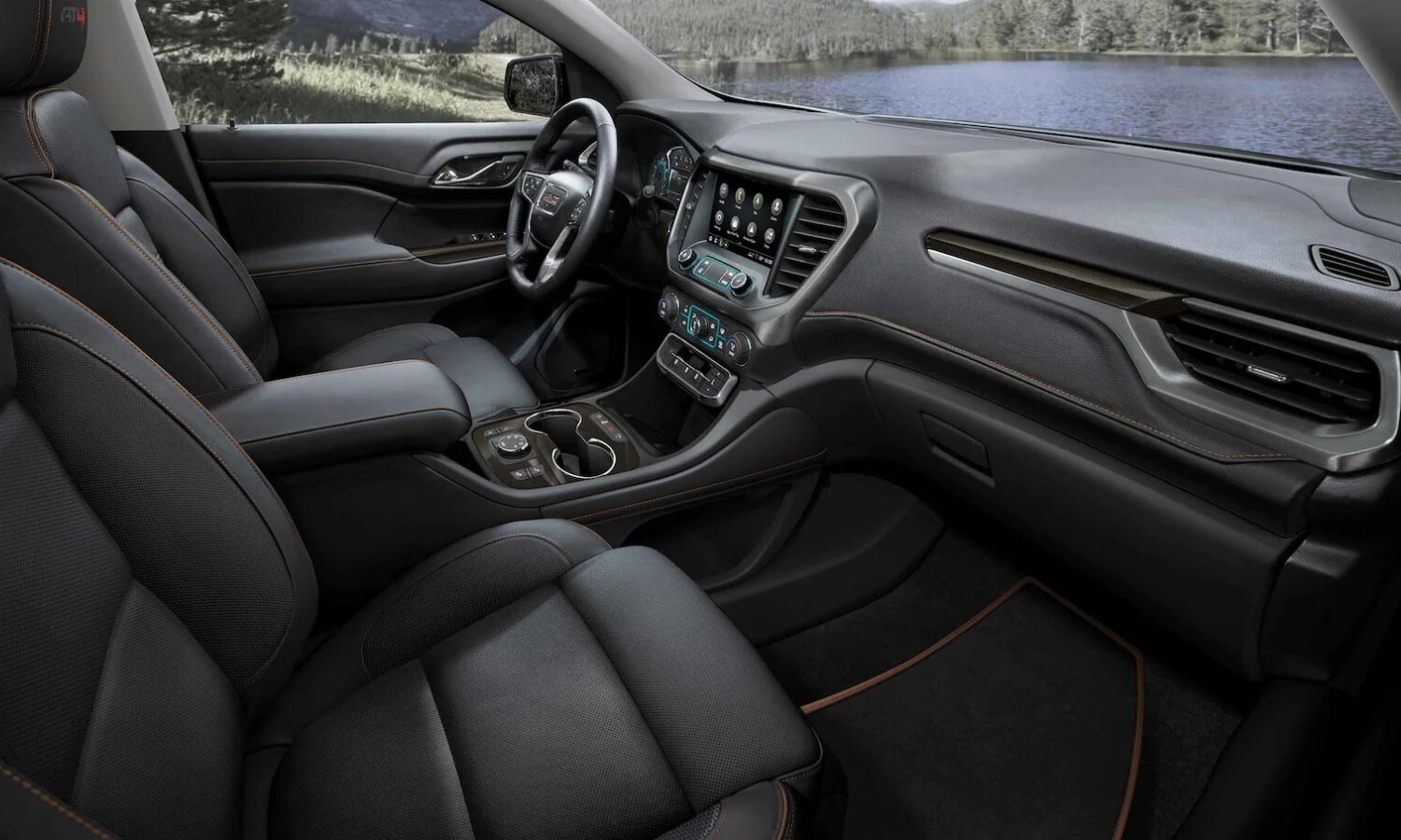 Interior view of the cabin inside the 2022 GMC Acadia SUV as you step into the front passenger seat