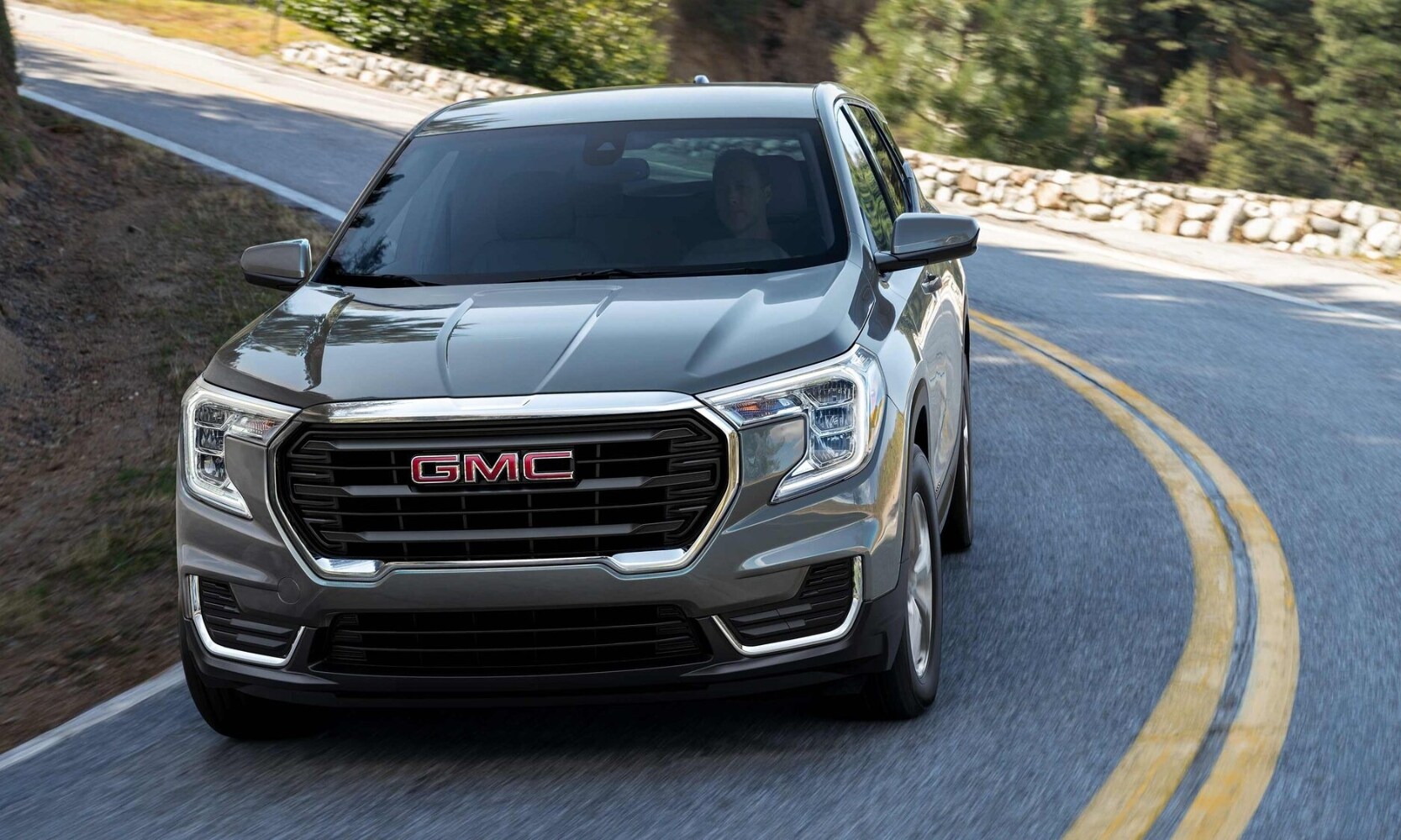 2023 GMC Terrain SLT driving around the bend of a curvy road