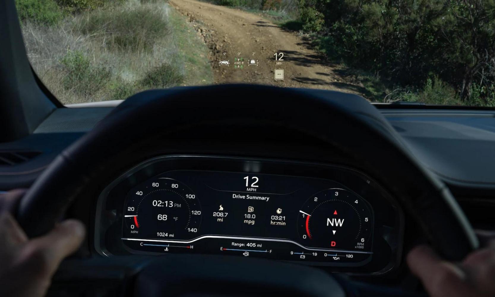 Driver's eye view of the head up display above the steering wheel inside the 2023 GMC Yukon AT4