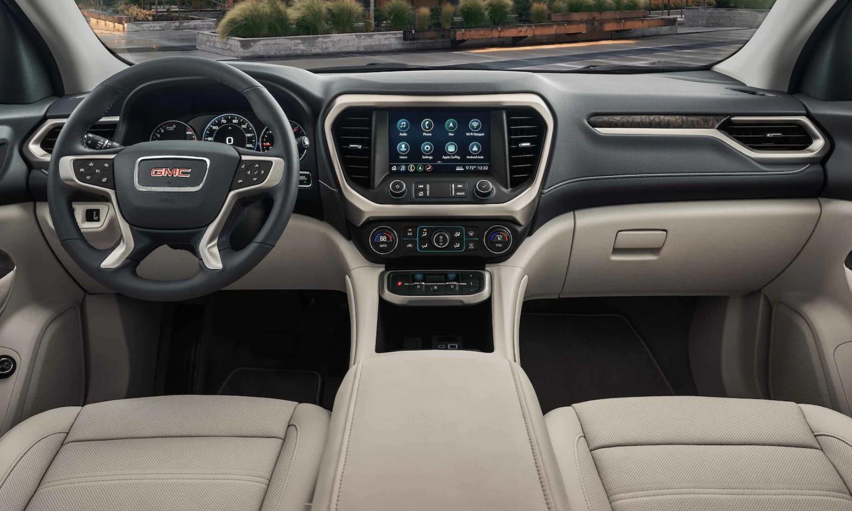 the front interior design inside the 2022 GMC Acadia showing the front dashboard and cabin area