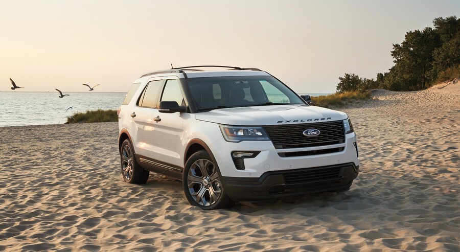 white Ford Explorer SUV parked on a beach