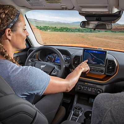 2025 Ford F-150® Lightning® pickup being driven on a mountainous roadway