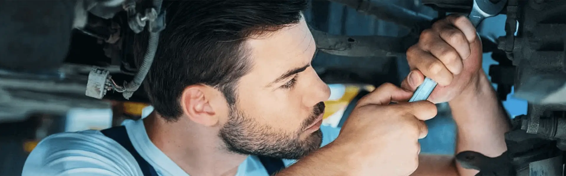 Ford Service Mechanic Working On A Vehicle 