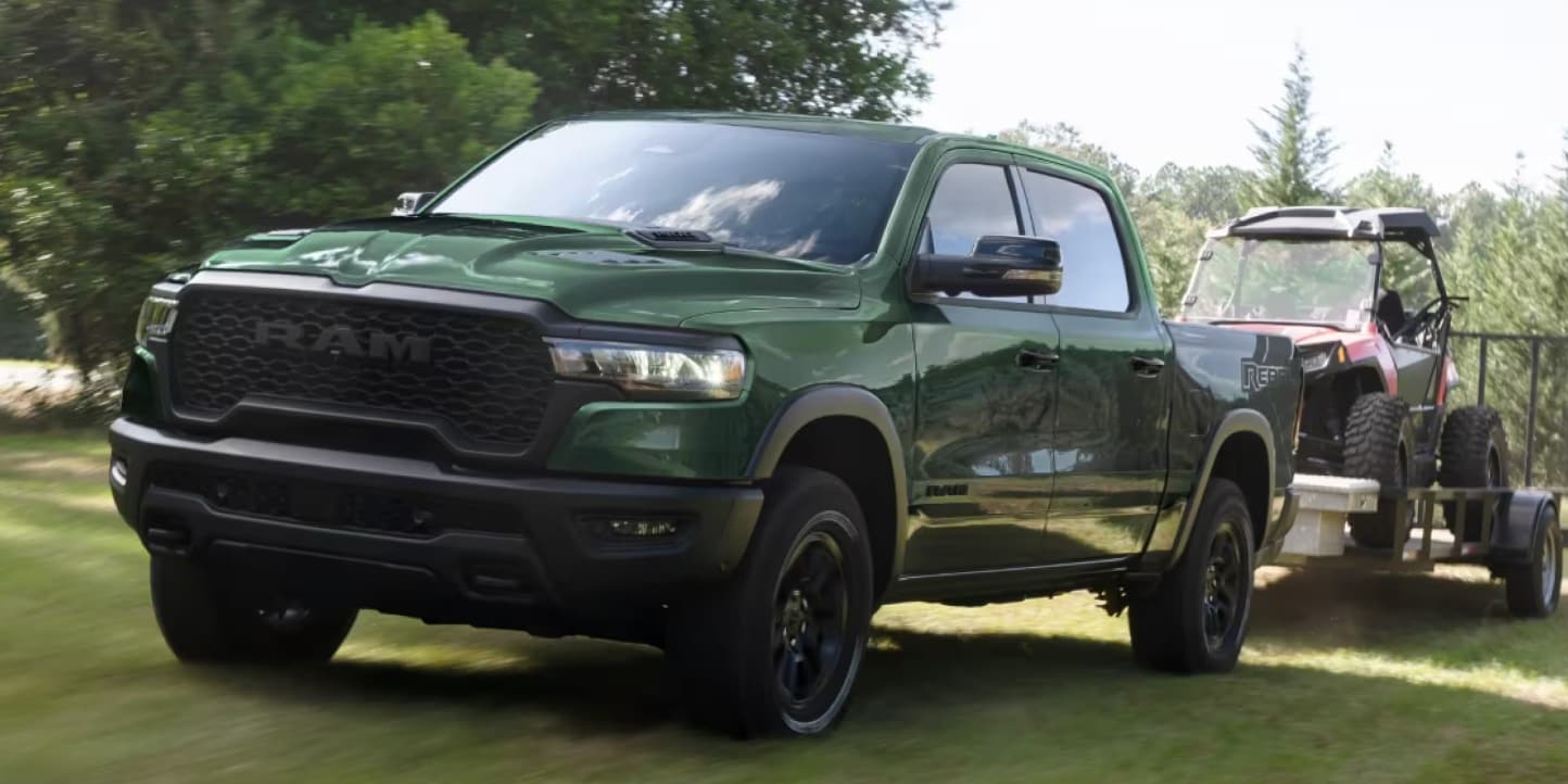 green 2026 Ram 1500 towing a trailer
