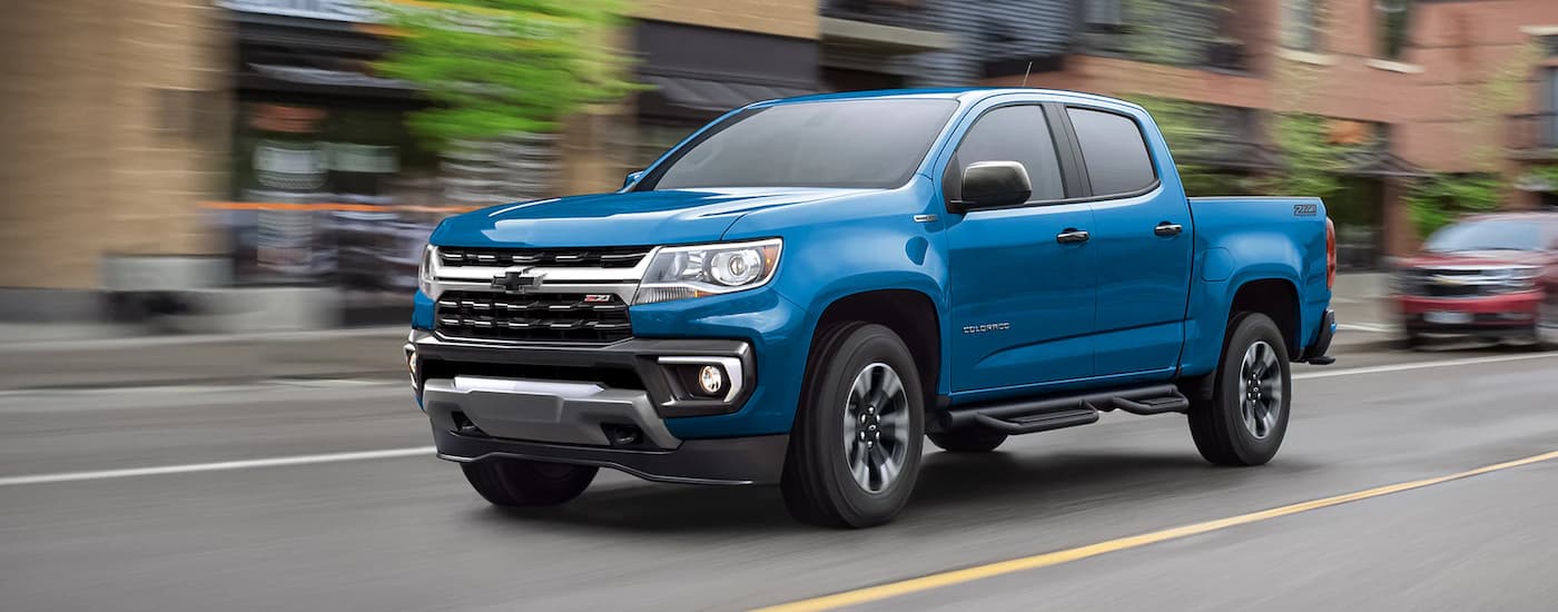 A blue 2022 Chevy Colorado Z71 driving on a city street.