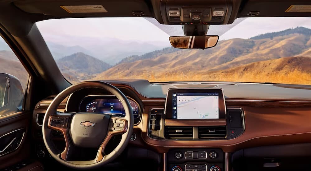 The brown interior and dash of a 2024 Chevy Tahoe is shown.