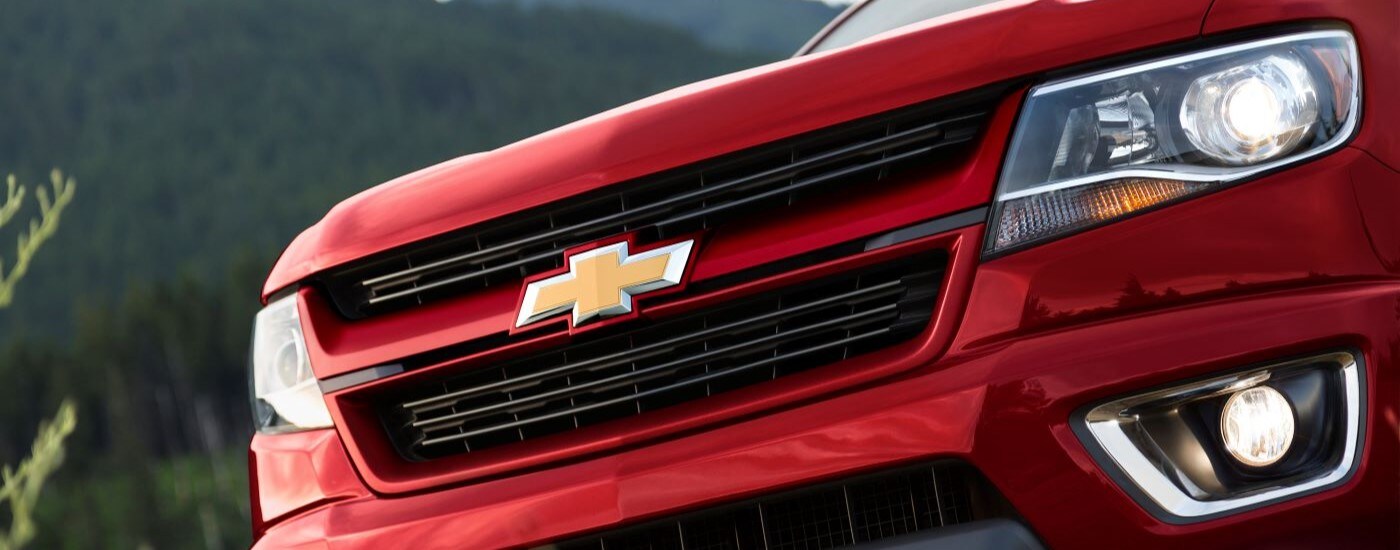 Close-up of the grille on a red 2015 Chevy Colorado.