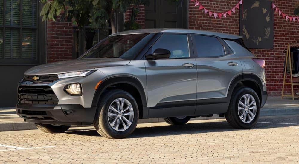 A silver 2023 Chevy Trailblazer is shown parked on the side of a city street.