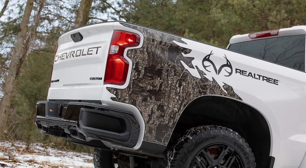 A close up of the rear of a white 2021 Chevy Silverado 1500 Realtree Edition is shown.