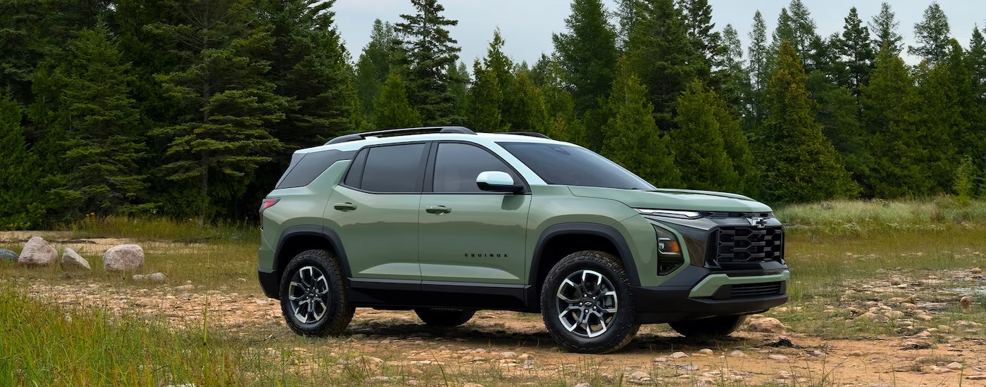 Chevy%20Equinox%20for%20Sale%20in%20Marlow%20Heights%20-%202025%20Chevy%20Equinox%20ACTIV%20-%20Trees%202.jpg A light green 2025 Chevy Equinox ACTIV parked in a wooded clearing.