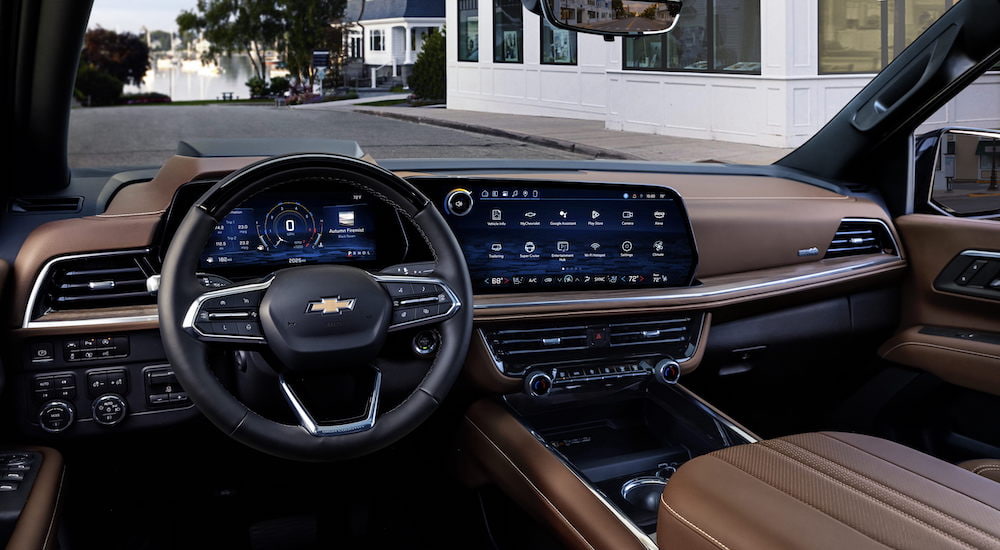 The brown interior of a 2025 Chevy Suburban High Country is shown from the driver's seat.