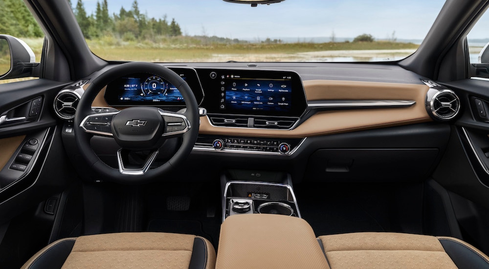 The tan interior of a 2025 Chevy Equinox ACTIV is shown from the center console.