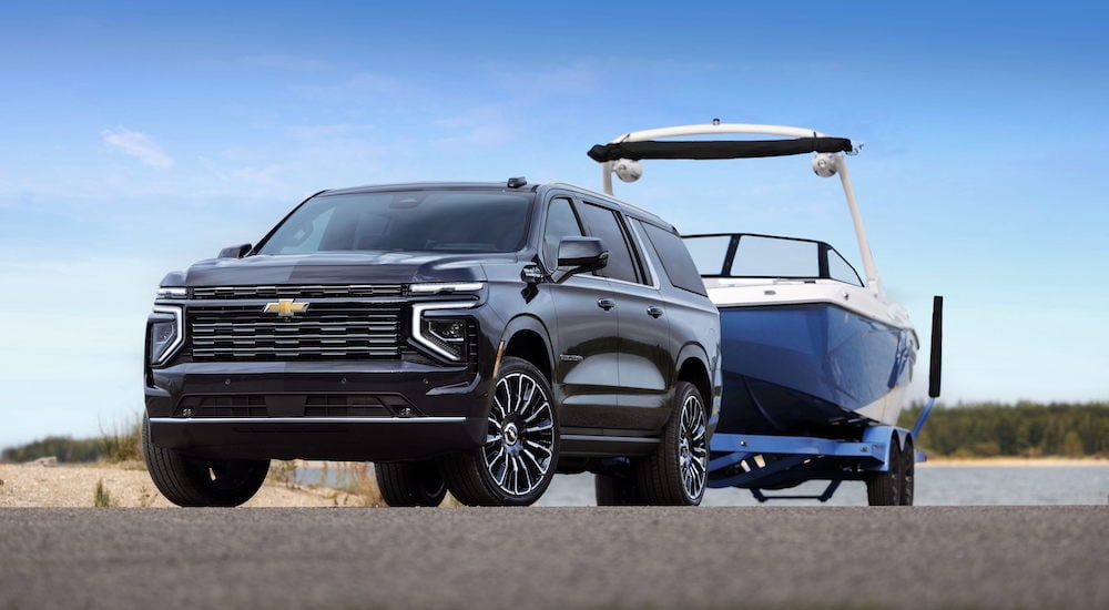 A black 2025 Chevy Suburban High Country is shown from the front at an angle after leaving a dealer that has Chevy SUVs for sale near Upper Marlboro.