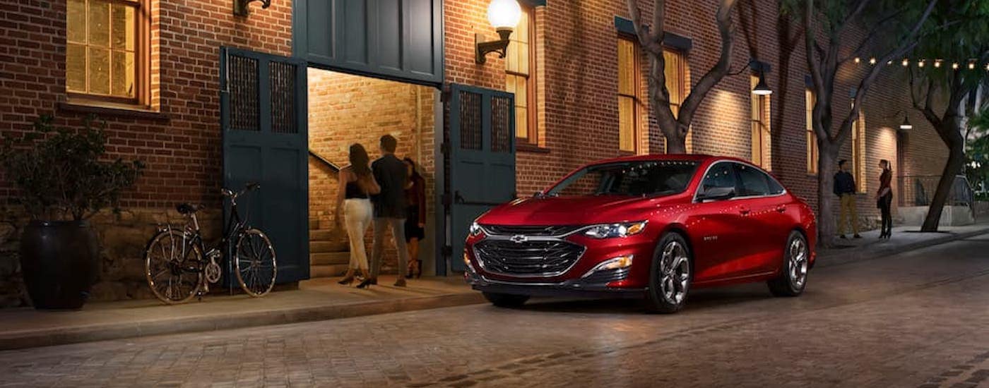 A red 2023 Chevy Malibu RS is shown from the front at an angle.