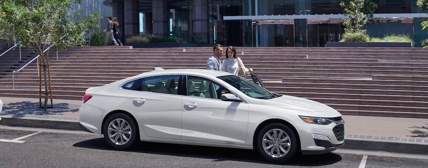 A white 2022 Chevy Malibu is shown from the side.