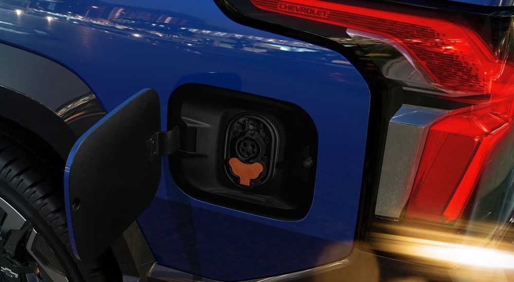 Close up of the charging port on a blue 2024 Chevy Silverado EV.